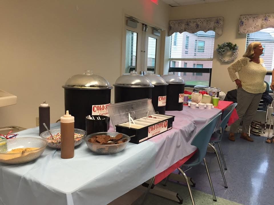 Cold Stone Creamery catering sundae bar set up indoors with toppings