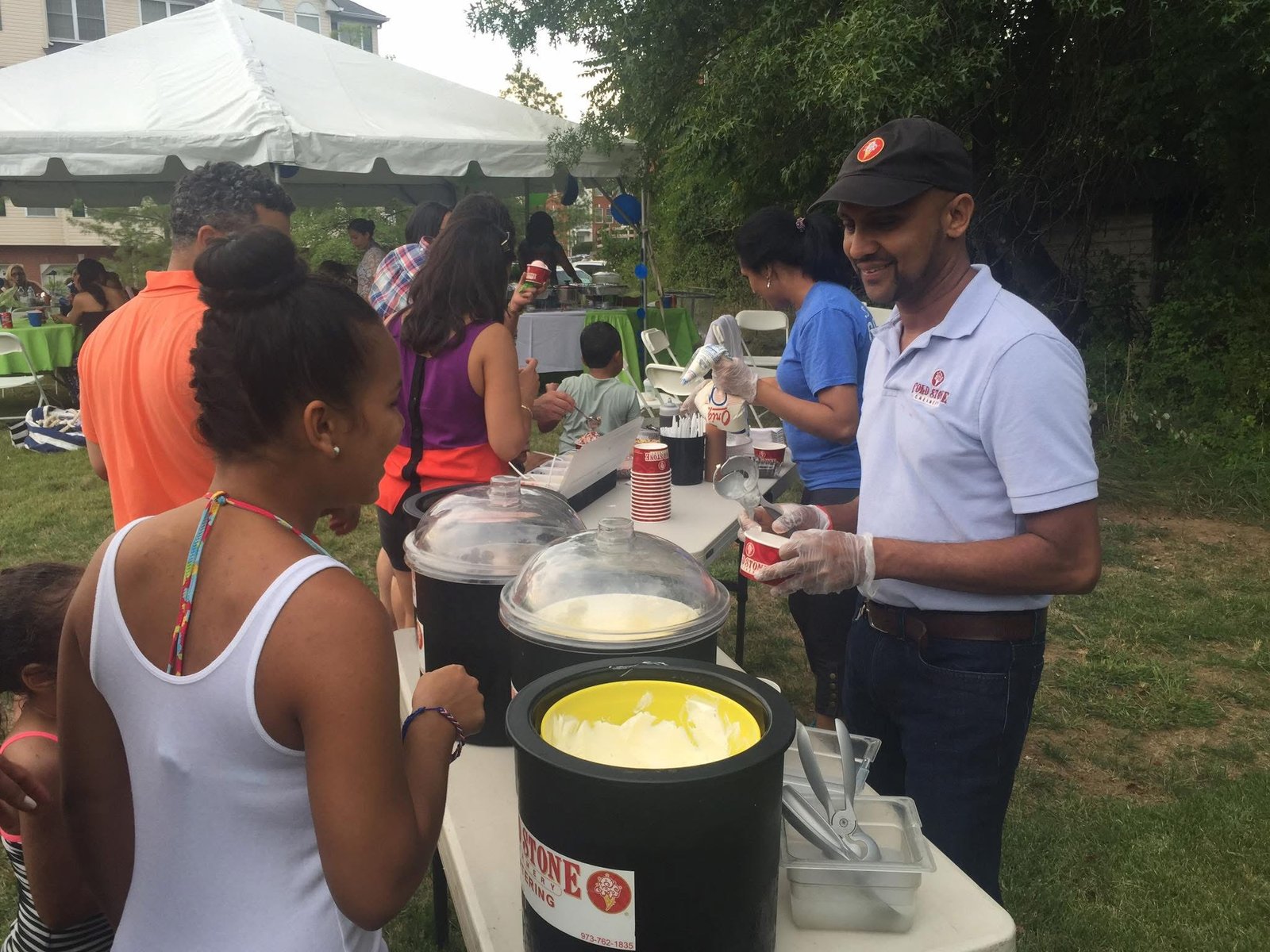 Cold Stone catering sundae bar serving guests at an outdoor event